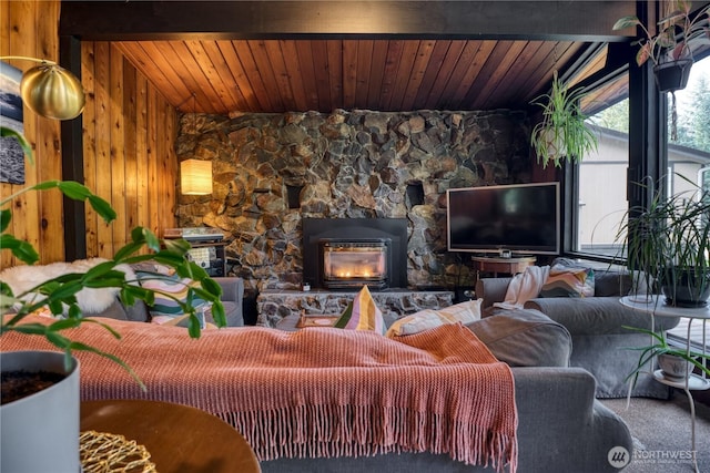 carpeted living room featuring a fireplace, vaulted ceiling, and wood ceiling