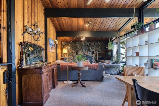 living room with beam ceiling, carpet flooring, and wooden ceiling