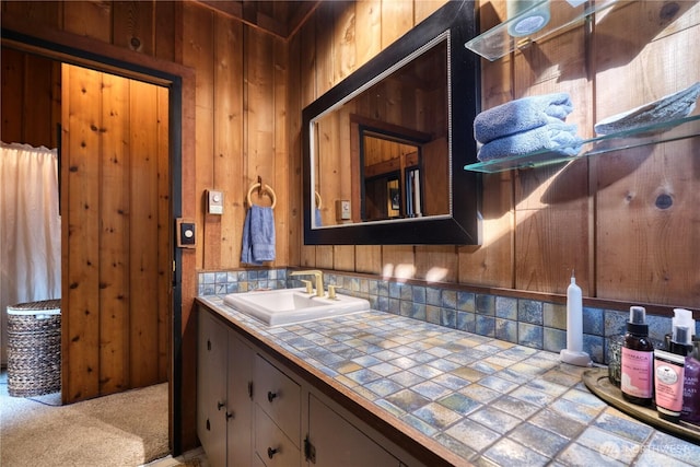 bathroom with vanity and wood walls