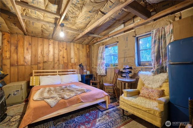 bedroom featuring freestanding refrigerator