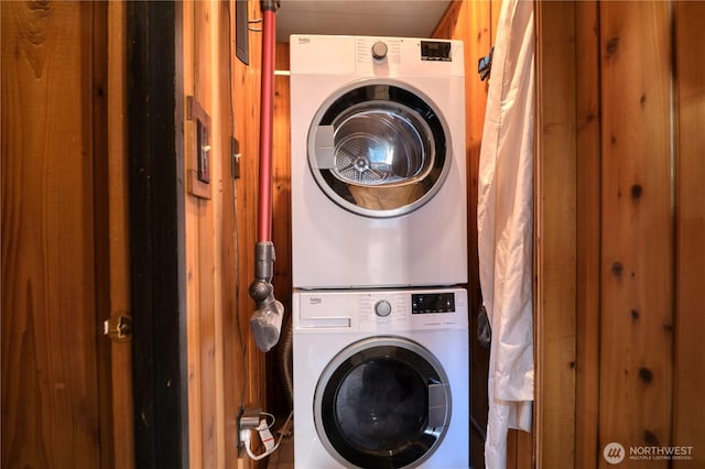 clothes washing area featuring laundry area and stacked washer / drying machine