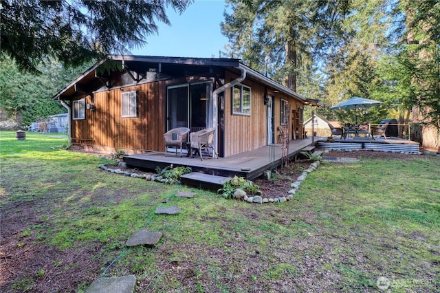 view of home's exterior featuring a yard and a deck