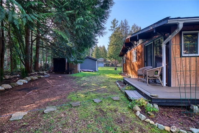 view of yard featuring an outbuilding and a wooden deck