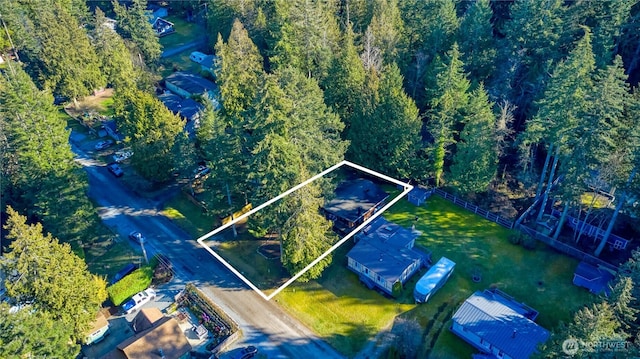 birds eye view of property with a wooded view