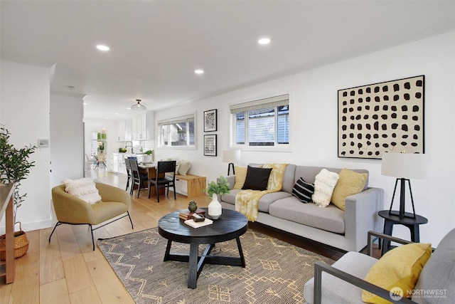 living area featuring a wealth of natural light, hardwood / wood-style flooring, and recessed lighting