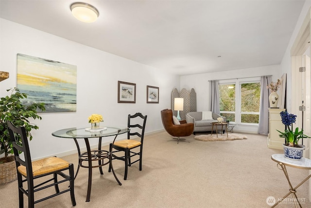 dining area featuring baseboards and carpet flooring