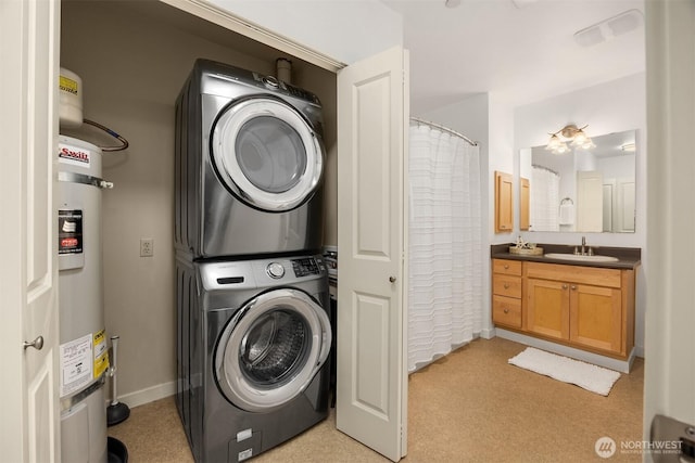 clothes washing area featuring laundry area, a sink, baseboards, stacked washing maching and dryer, and strapped water heater