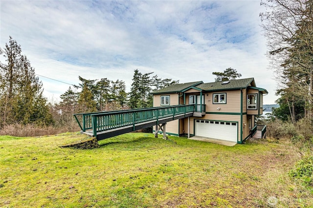 view of front of house with driveway, a front yard, and a wooden deck