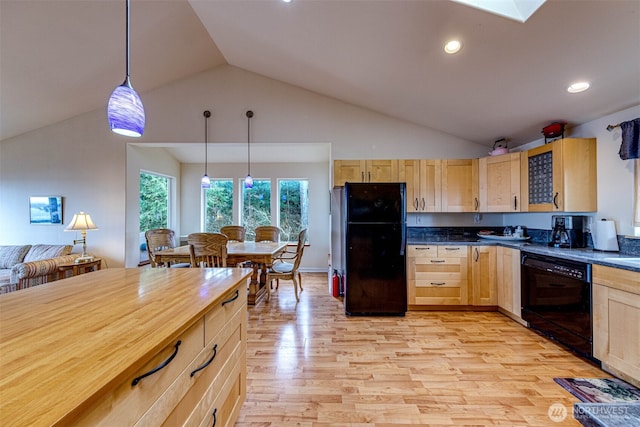 kitchen with black appliances, decorative light fixtures, light wood-style floors, and light brown cabinetry