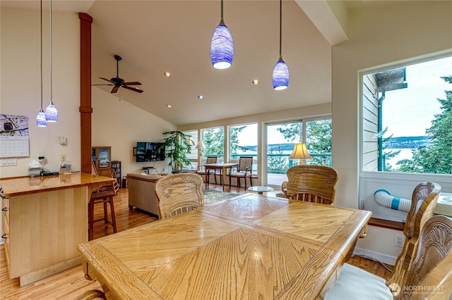 dining space with light wood-style floors, recessed lighting, ceiling fan, and high vaulted ceiling