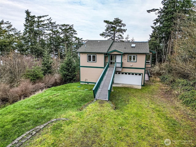 view of front of house featuring a garage, driveway, a front lawn, and stairway