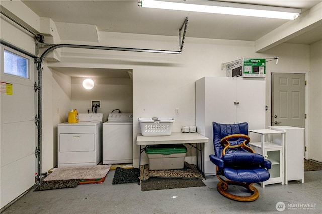 laundry room featuring a garage and separate washer and dryer