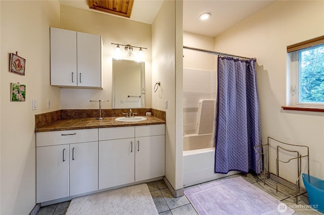 full bath featuring shower / tub combo with curtain, vanity, and tile patterned floors