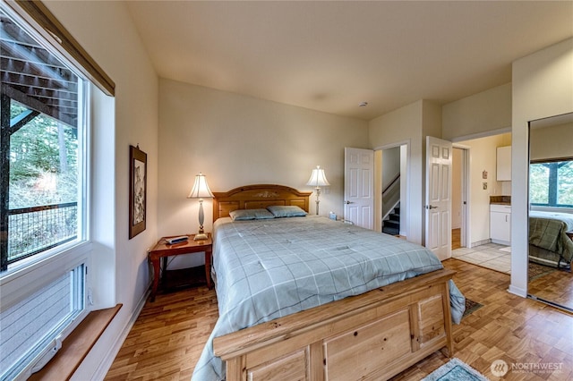 bedroom featuring light wood-type flooring and baseboards