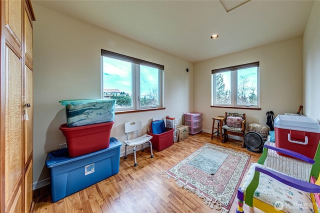 interior space with plenty of natural light, wood finished floors, and baseboards