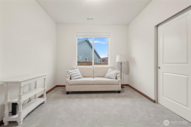 living area with carpet floors, baseboards, and visible vents