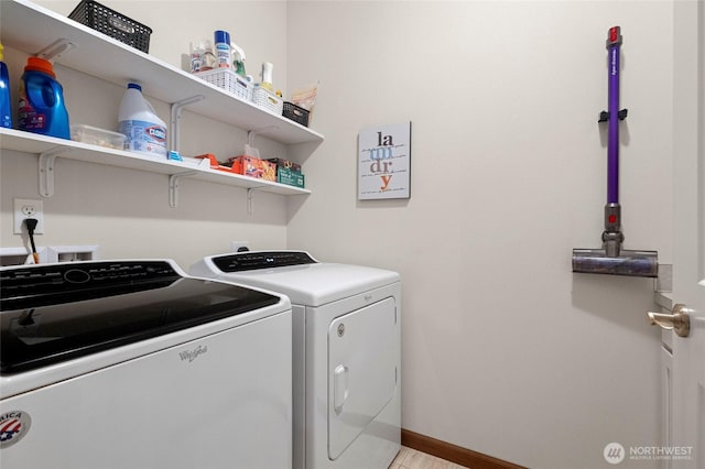 laundry area with laundry area, baseboards, and separate washer and dryer