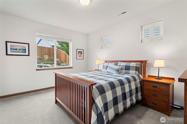 carpeted bedroom with visible vents and baseboards