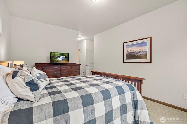 carpeted bedroom featuring baseboards