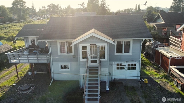 view of front of home featuring fence and stairs