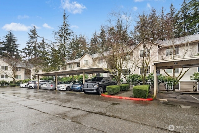 partially covered parking lot featuring a residential view