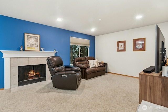 carpeted living room with recessed lighting, a tile fireplace, and baseboards