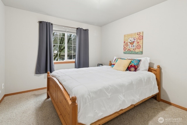 carpeted bedroom with baseboards