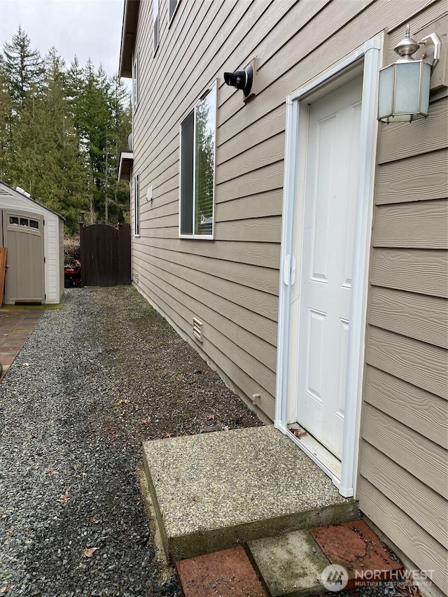 view of home's exterior featuring a storage shed and an outbuilding