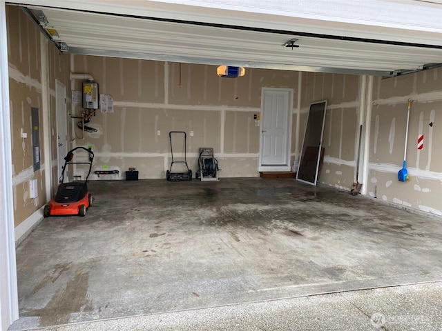 garage featuring a garage door opener and water heater