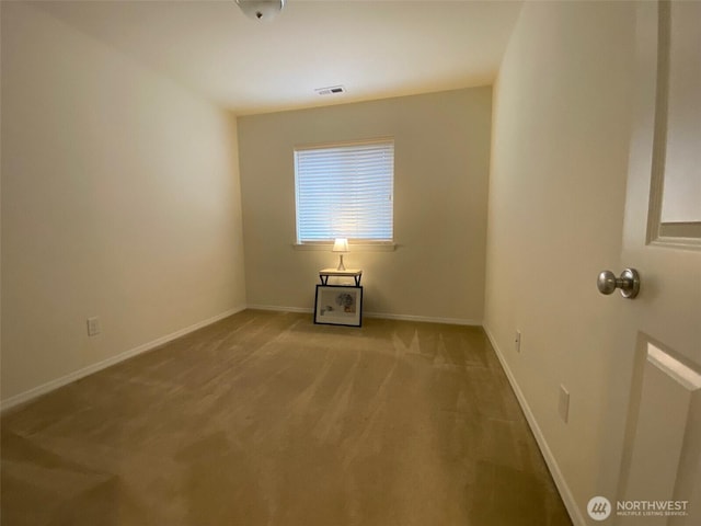 empty room featuring light carpet, baseboards, and visible vents