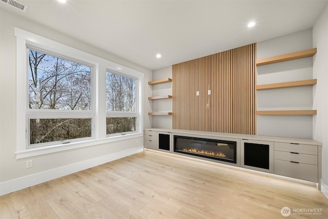 unfurnished living room featuring built in features, recessed lighting, visible vents, light wood-style flooring, and baseboards