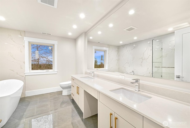 full bathroom with double vanity, a soaking tub, a sink, and visible vents