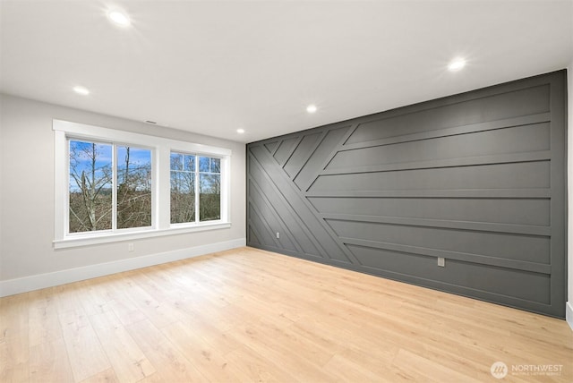 spare room featuring recessed lighting, light wood-style flooring, and baseboards