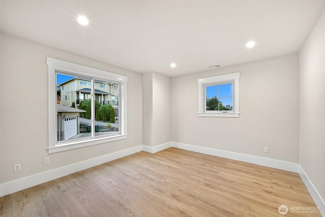 spare room featuring recessed lighting, baseboards, visible vents, and light wood finished floors