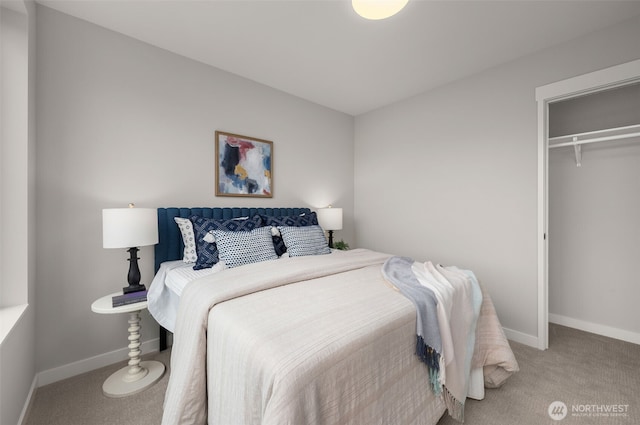 carpeted bedroom with a closet and baseboards