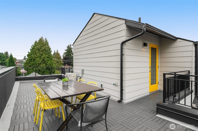 wooden deck featuring outdoor dining area