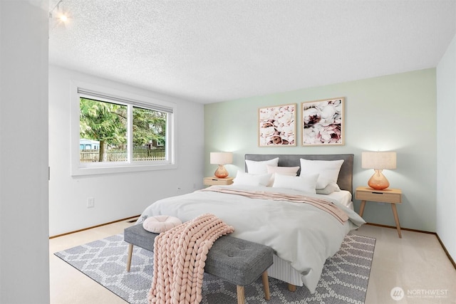 bedroom featuring a textured ceiling and baseboards