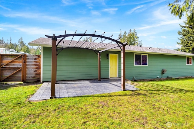 back of house featuring a yard, fence, a pergola, and a patio