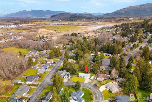 drone / aerial view featuring a residential view and a mountain view