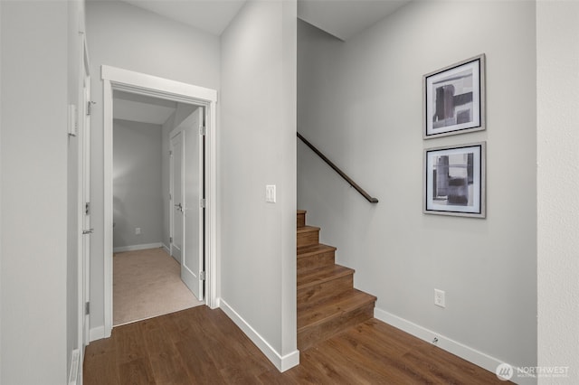 stairs with baseboards and wood finished floors