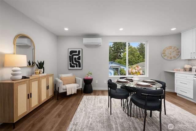 dining area with baseboards, an AC wall unit, dark wood-type flooring, and recessed lighting