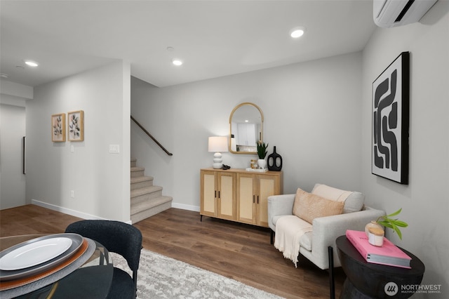 living area featuring dark wood-style floors, recessed lighting, stairway, and a wall mounted AC