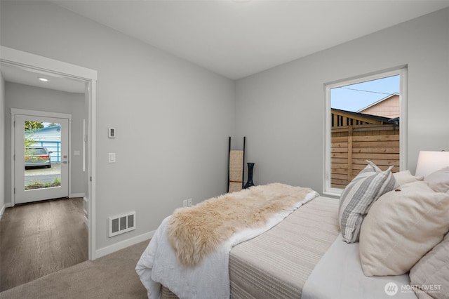 carpeted bedroom featuring visible vents and baseboards