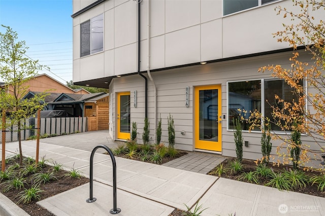 view of front of home with a patio area and fence