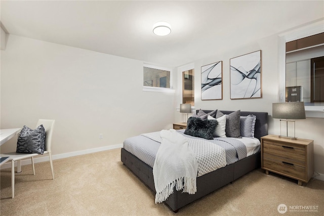 bedroom featuring baseboards and light colored carpet