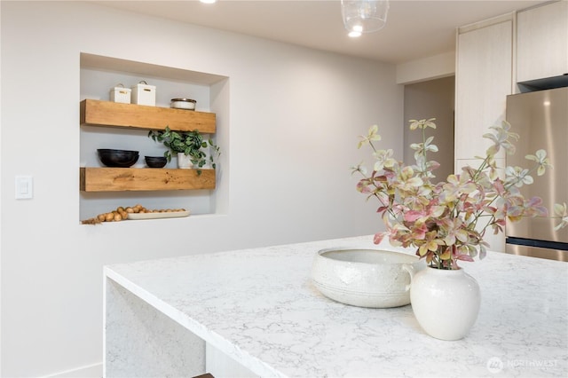 room details featuring light countertops and freestanding refrigerator