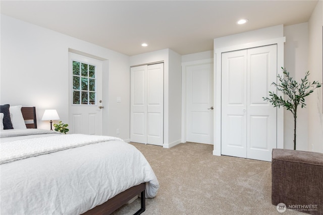 bedroom featuring recessed lighting, baseboards, carpet, and multiple closets