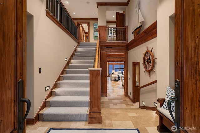 stairway with recessed lighting, a towering ceiling, and baseboards