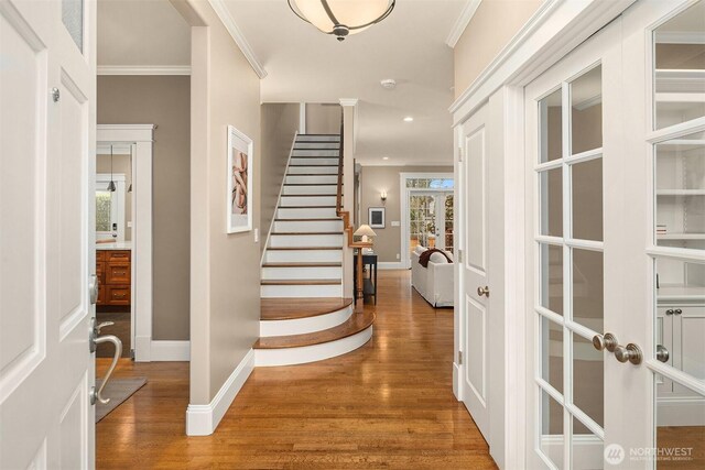 2311 42nd Ave E, Seattle, WA 98112 - foyer with crown molding, stairway, wood finished floors, and baseboards