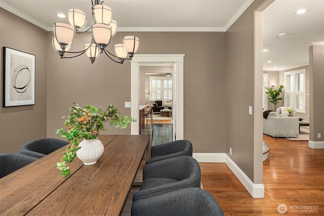 2311 42nd Ave E, Seattle, WA 98112 - dining space featuring baseboards, wood finished floors, a notable chandelier, and ornamental molding